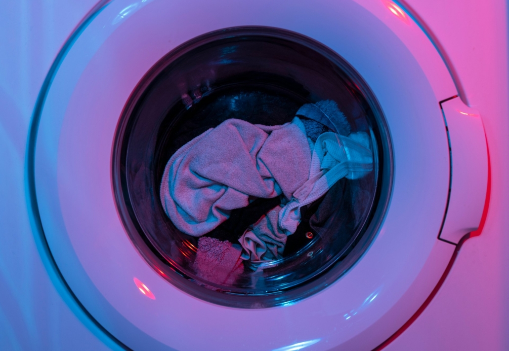 Close-up van een draaiende wasmachine met kleding, symbool voor het gemak en de flexibiliteit van het huren van een wasmachine.